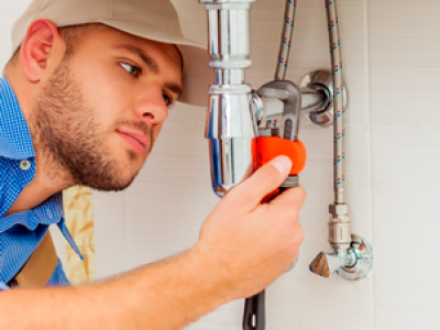 man fixing sink with tool